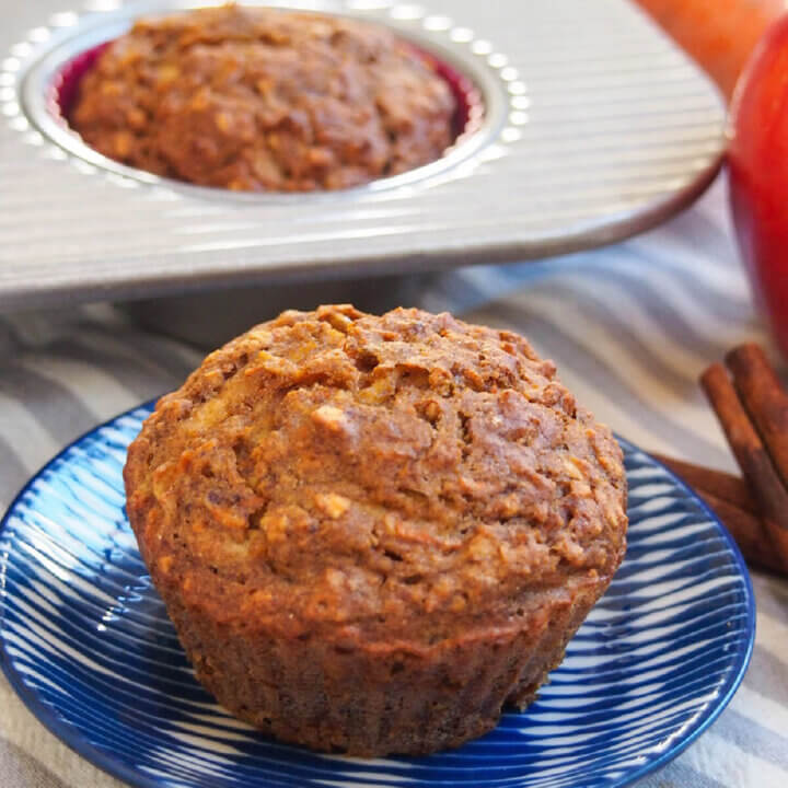 carrot apple muffin on plate with another in tray behind