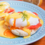 Eggs Royale (smoked salmon eggs Benedict) with yolk oozing into sauce