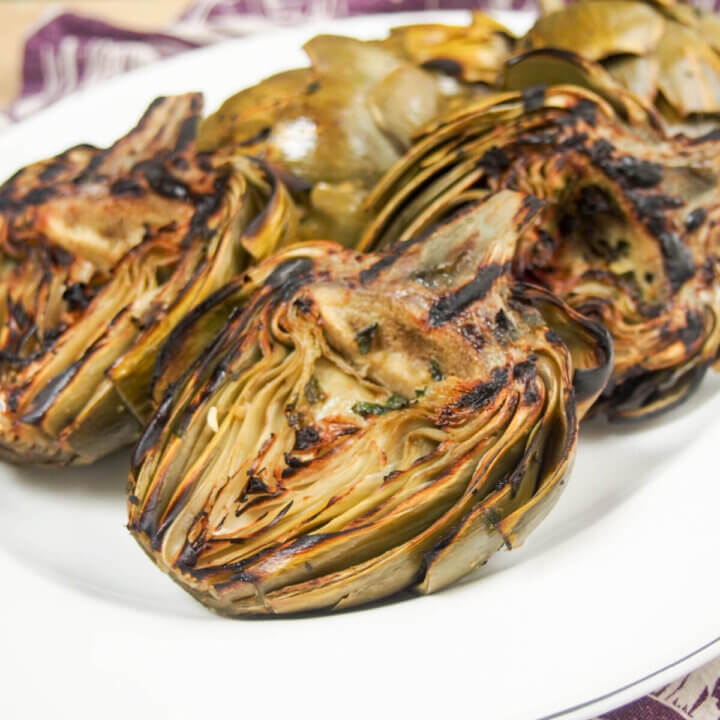plate of grilled artichokes showing grill marks on artichokes