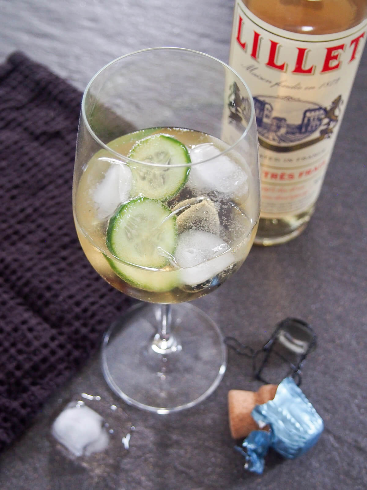 glass of lillet spritz with cucumber and ice in glass