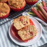 rhubarb muffin on plate with rhubarb to side