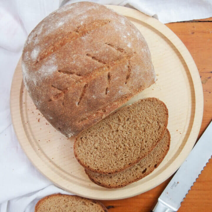 loaf of sourdough rye bread with a couple slices cut from overhead