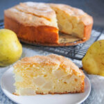slice of French pear cake in front of rest of cake
