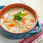 bowl of Scotch broth topped with parsley garnish