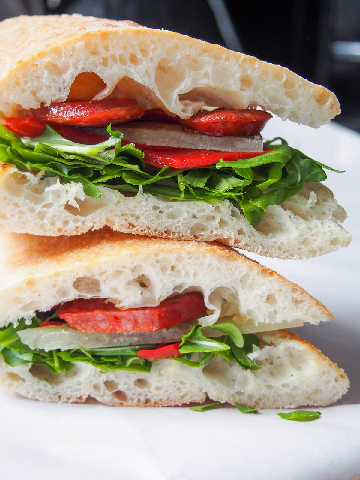 two halves of sandwich stacked on top of each other close up