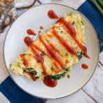 plate with Taiwanese oyster omelette topped with sauce