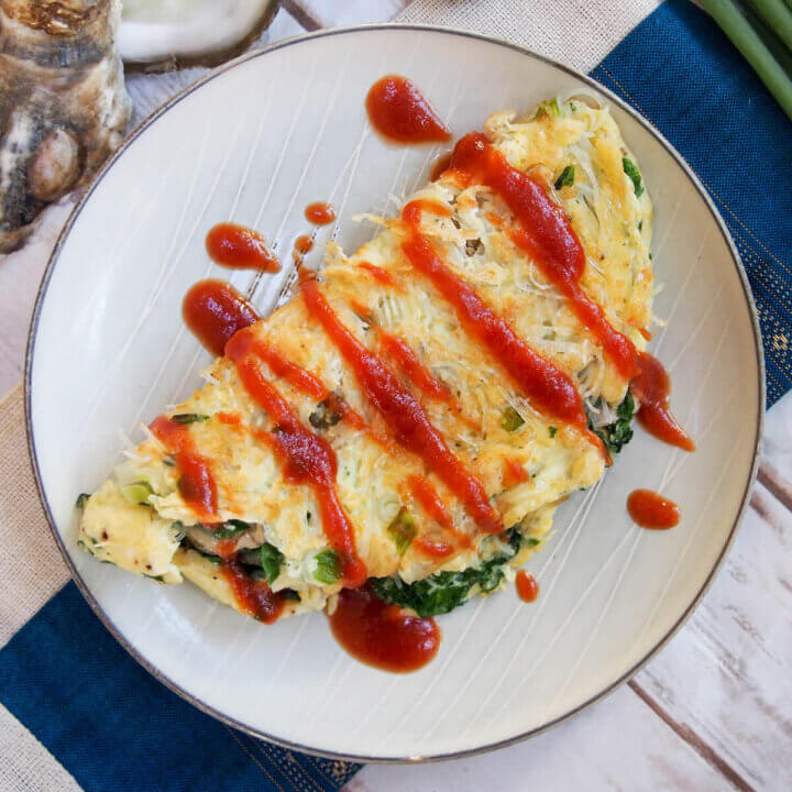 plate with Taiwanese oyster omelette topped with sauce
