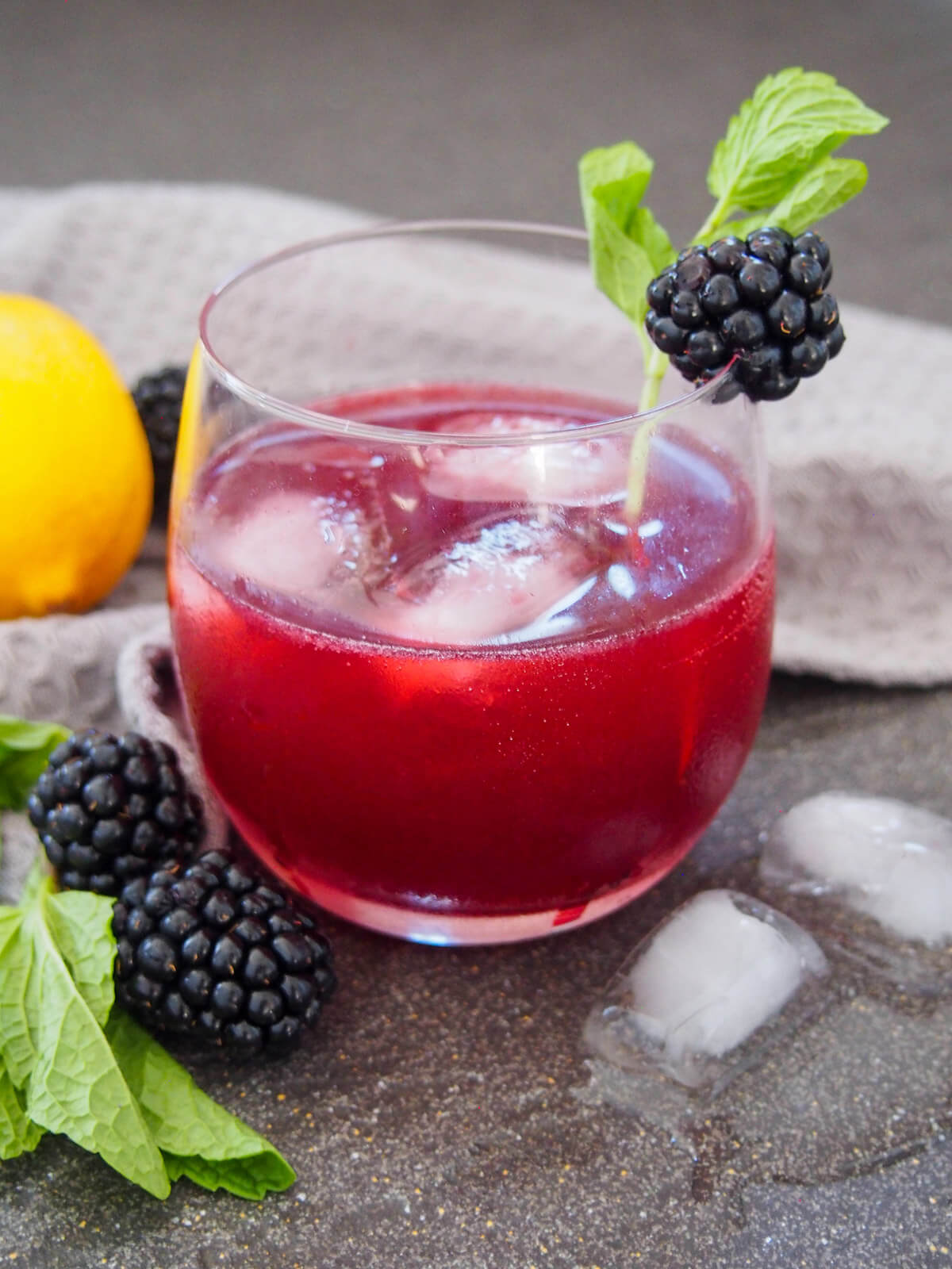 side view of glass of blackberry bourbon smash