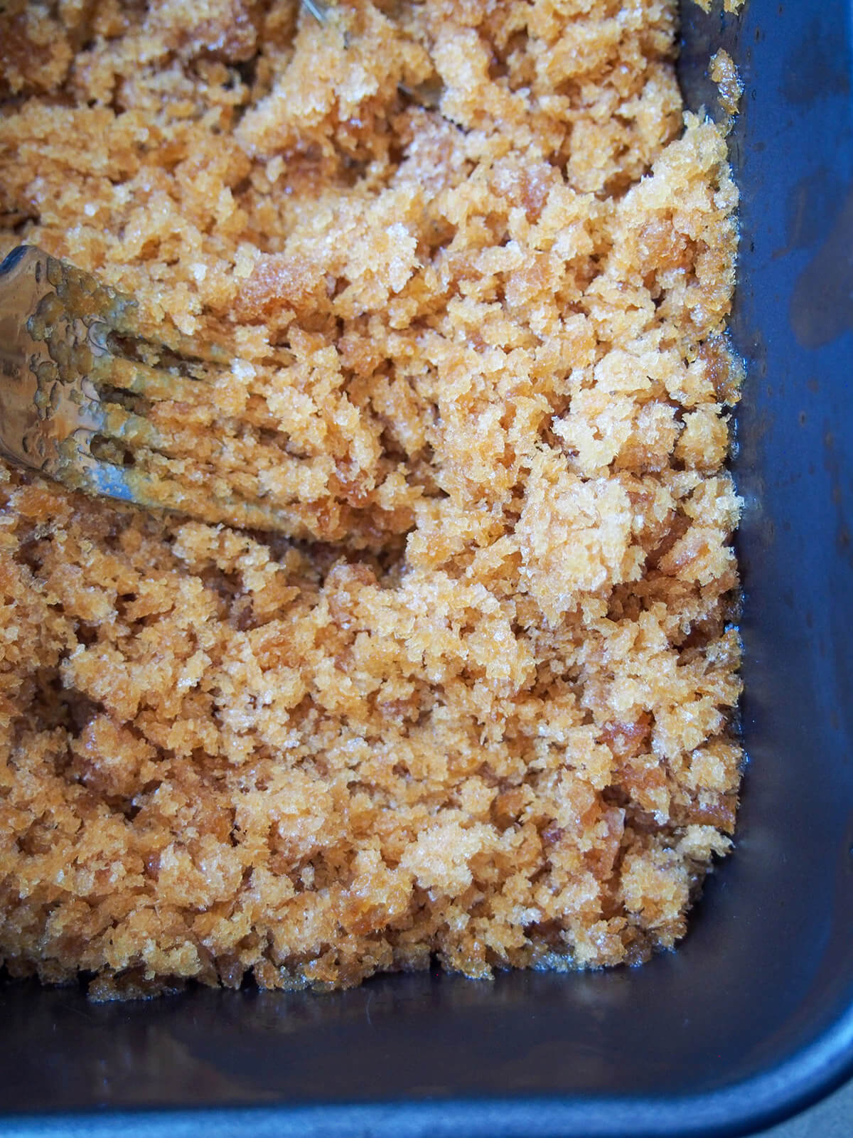 broken up coffee granita in dish with fork in it