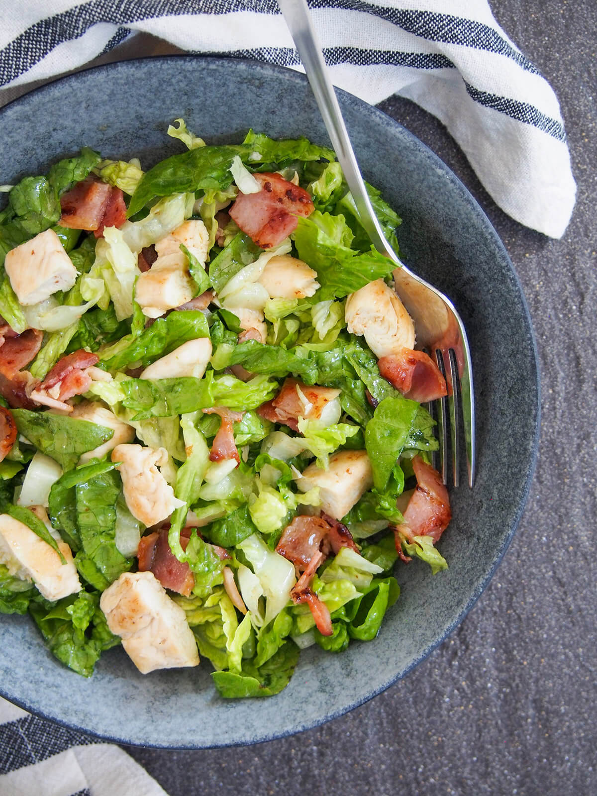 chicken and bacon salad with fork in side of bowl
