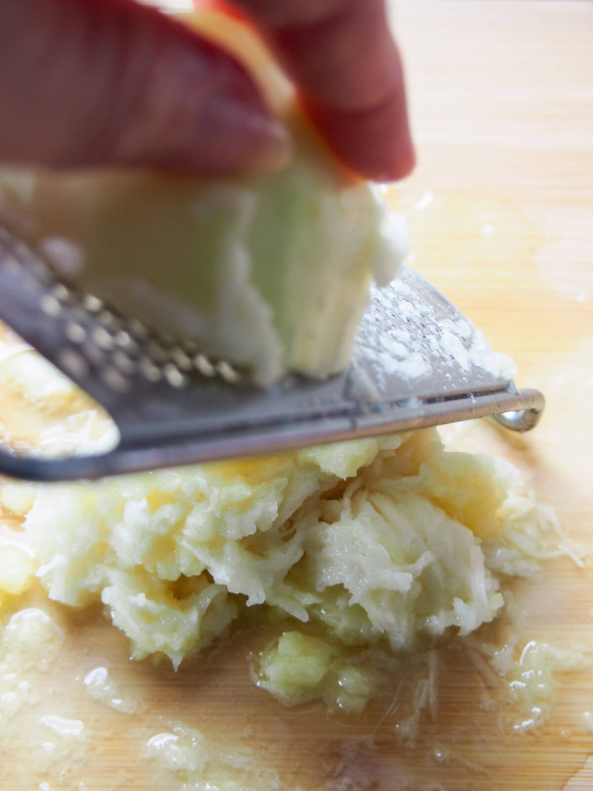 finely grating potato