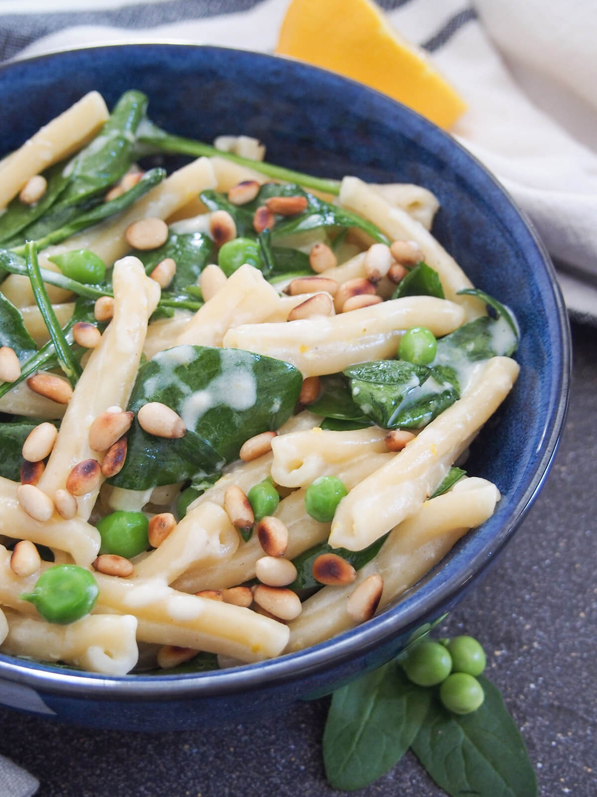 close up view of lemon mascarpone pasta in blue bowl