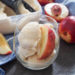 glass with nectarine ice cream and tub behind