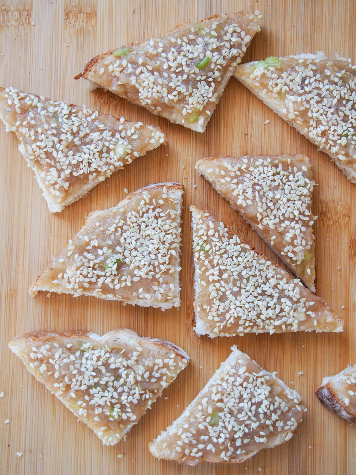 sesame shrimp toast before cooking on wooden board