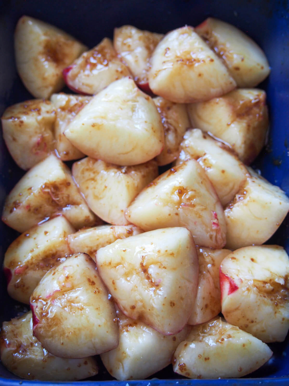 nectarine chunks on roasting dish with sugar
