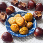 plate of roasted chestnuts with more around