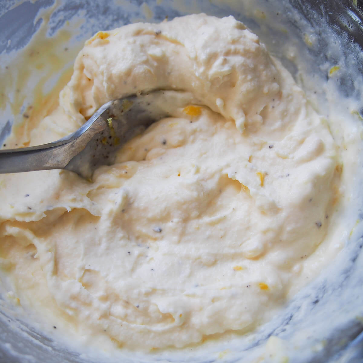 lemon mascarpone sauce in bowl with spoon in it