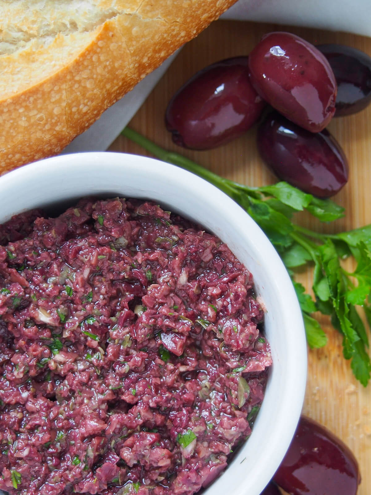 close up of dish of tapenade with black olives to side of dish