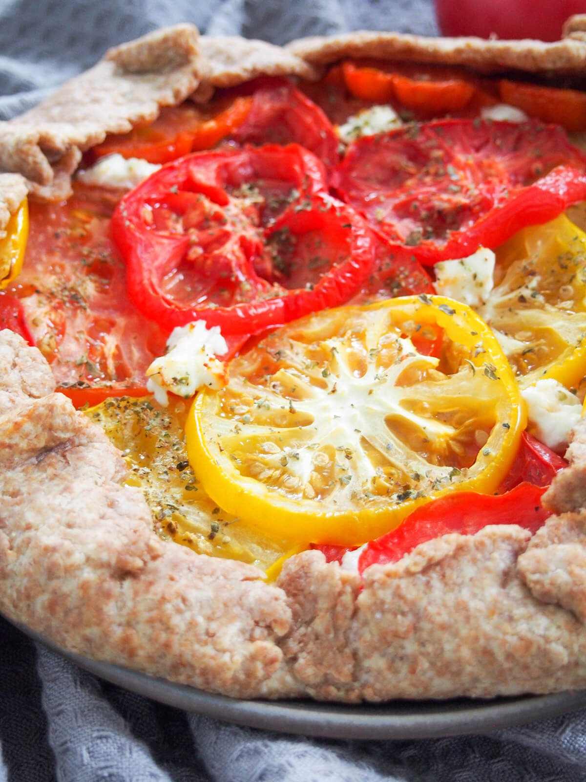 side view of tomato galette showing slices of tomato on top
