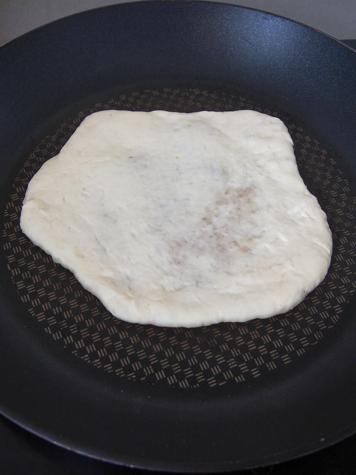 cooking naan in skillet