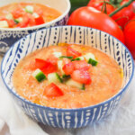 bowl of gazpacho with tomato and cucumber garnish