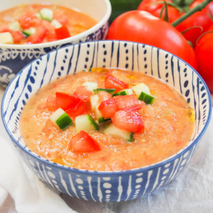 bowl of gazpacho with tomato and cucumber garnish