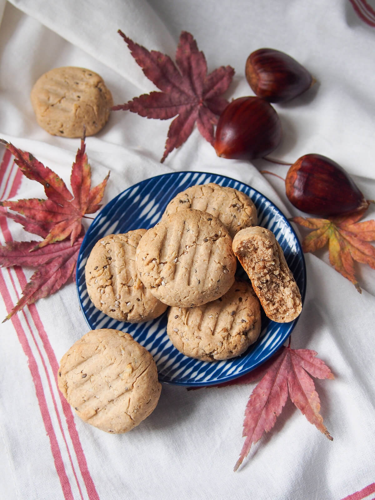 plate of gluten free maple chestnut cookies from overhead with leaves and chestnuts around