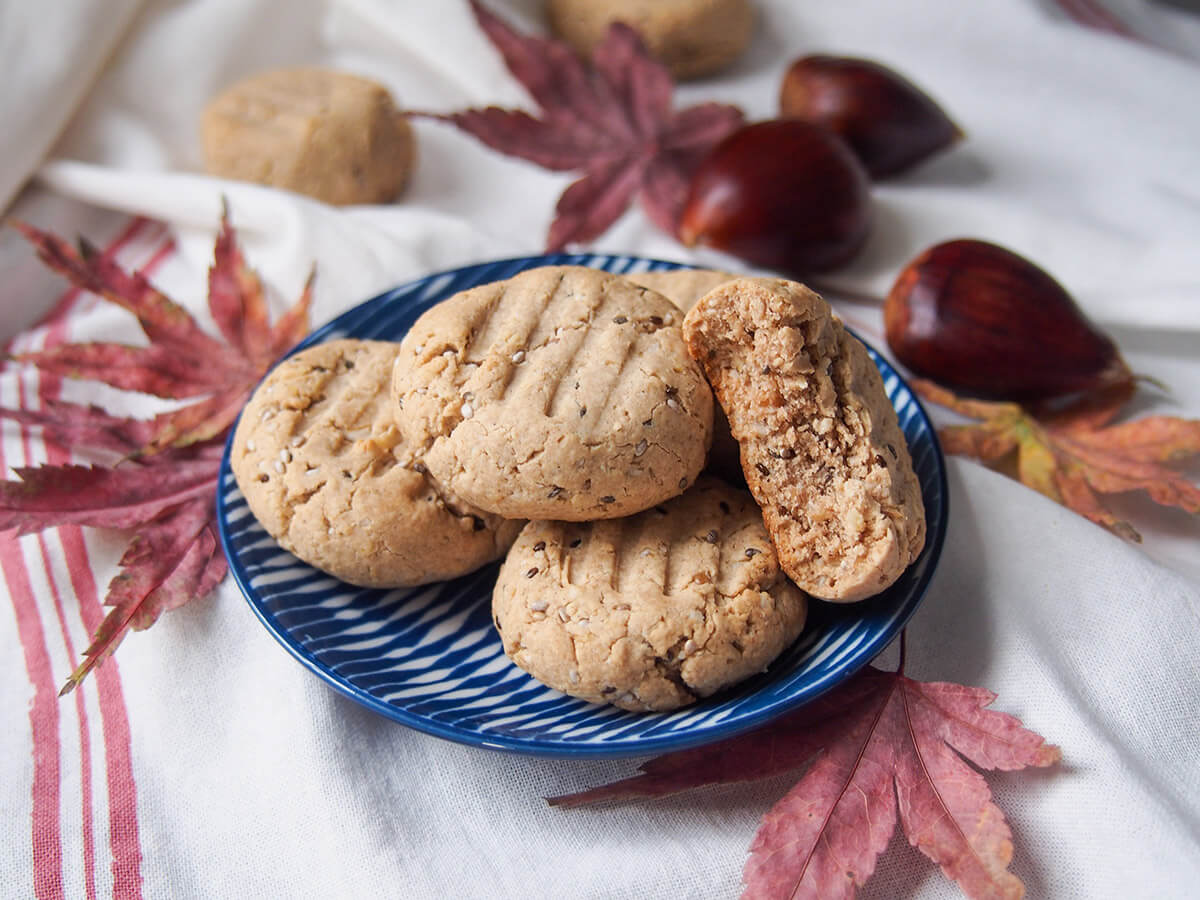 plate of gluten free maple chestnut cookies with chestnuts behind