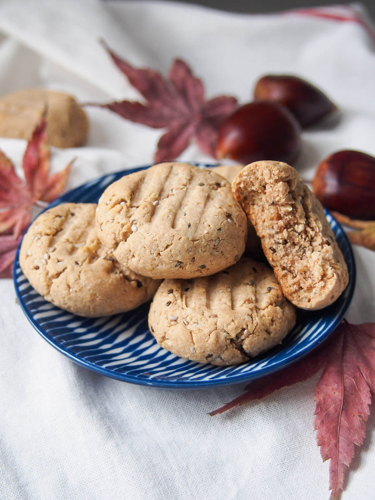 plate of gluten free maple chestnut cookies with one bitten resting to side