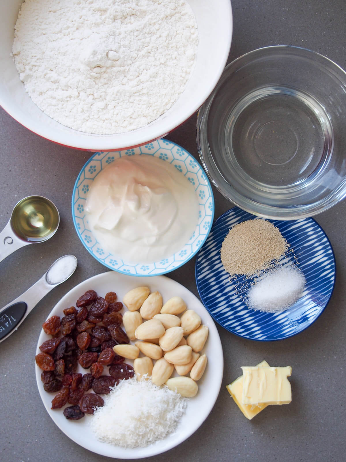 bowls with flour, water, yogurt, yeast, nuts and raisins