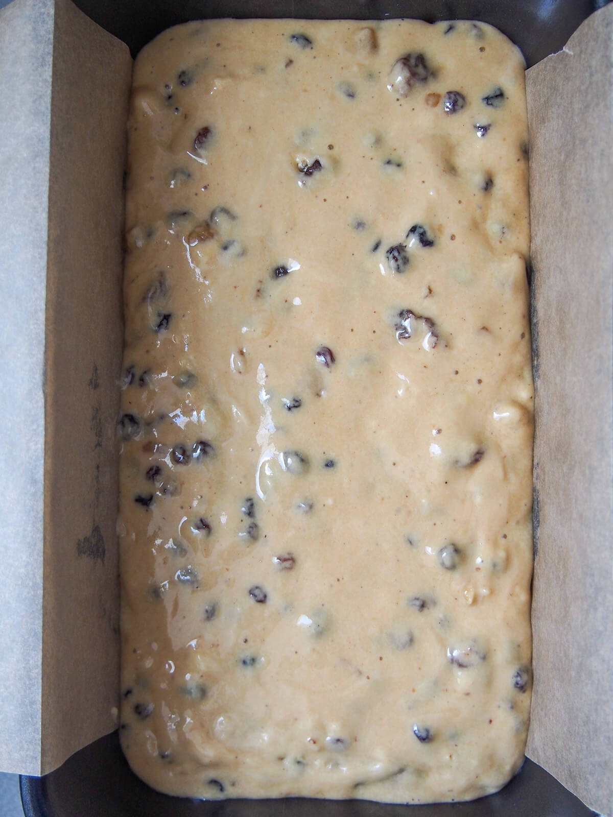 Irish brack batter in loaf tin before baking mixture in lined loaf tin ready to bake