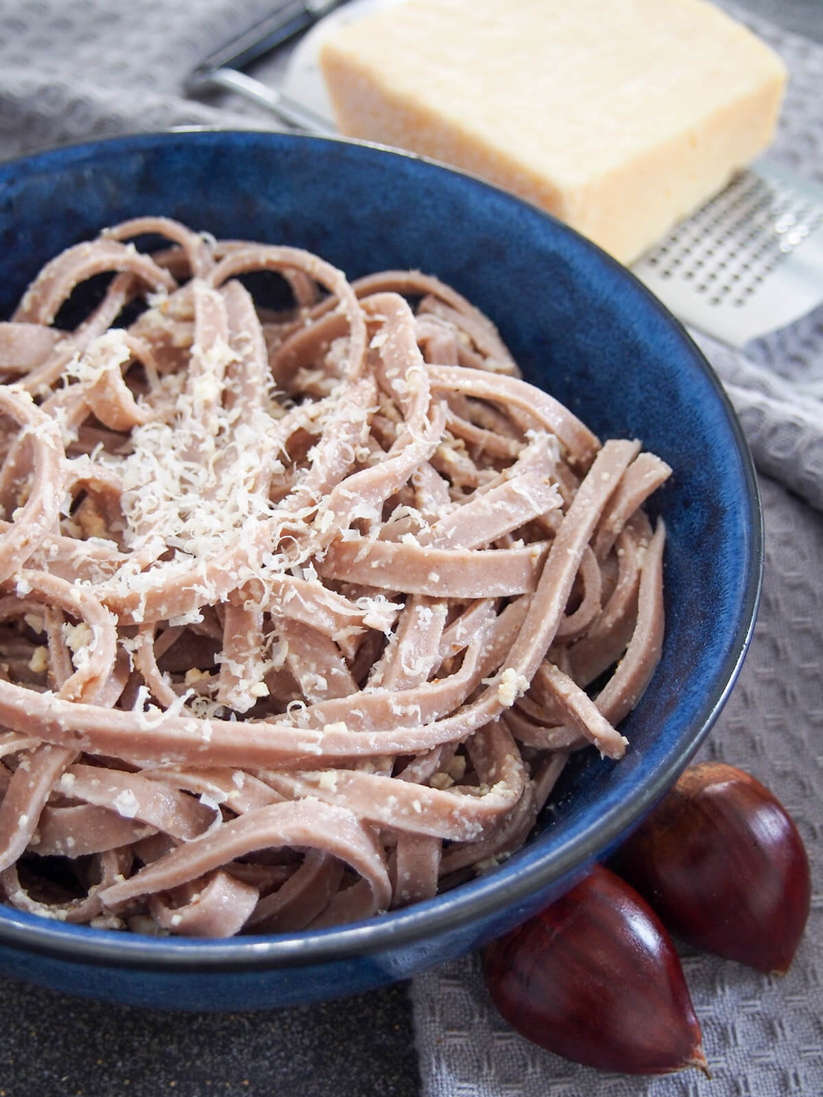 This chestnut pasta is a wonderfully tasty homemade pasta with a gently sweet, nutty flavor. It's easy to make and cooks up in no time. It pairs perfectly with simple sauces for comfort food deliciousness. side view of bowl of chestnut pasta.