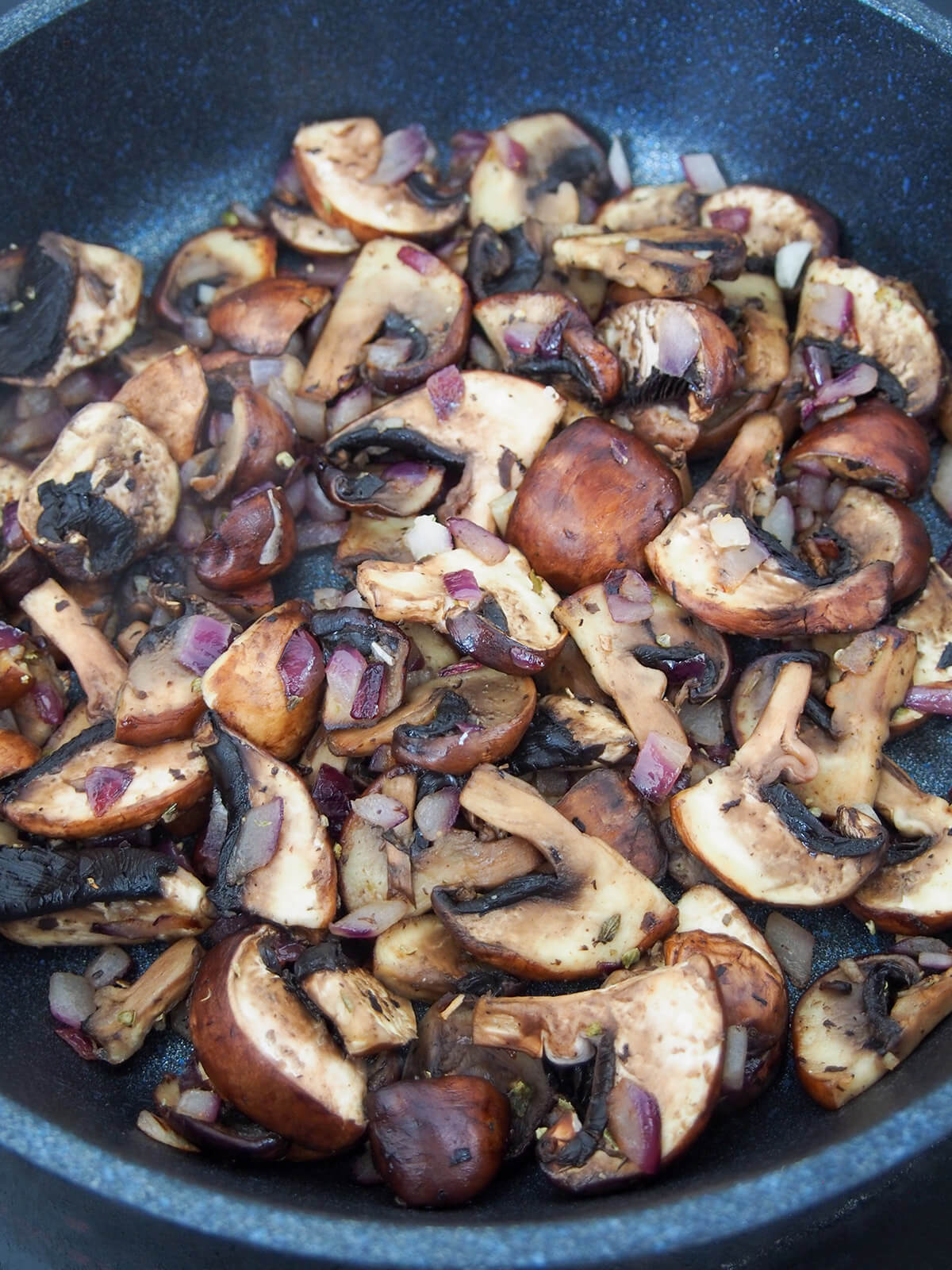 cooking mushrooms and onions in skillet