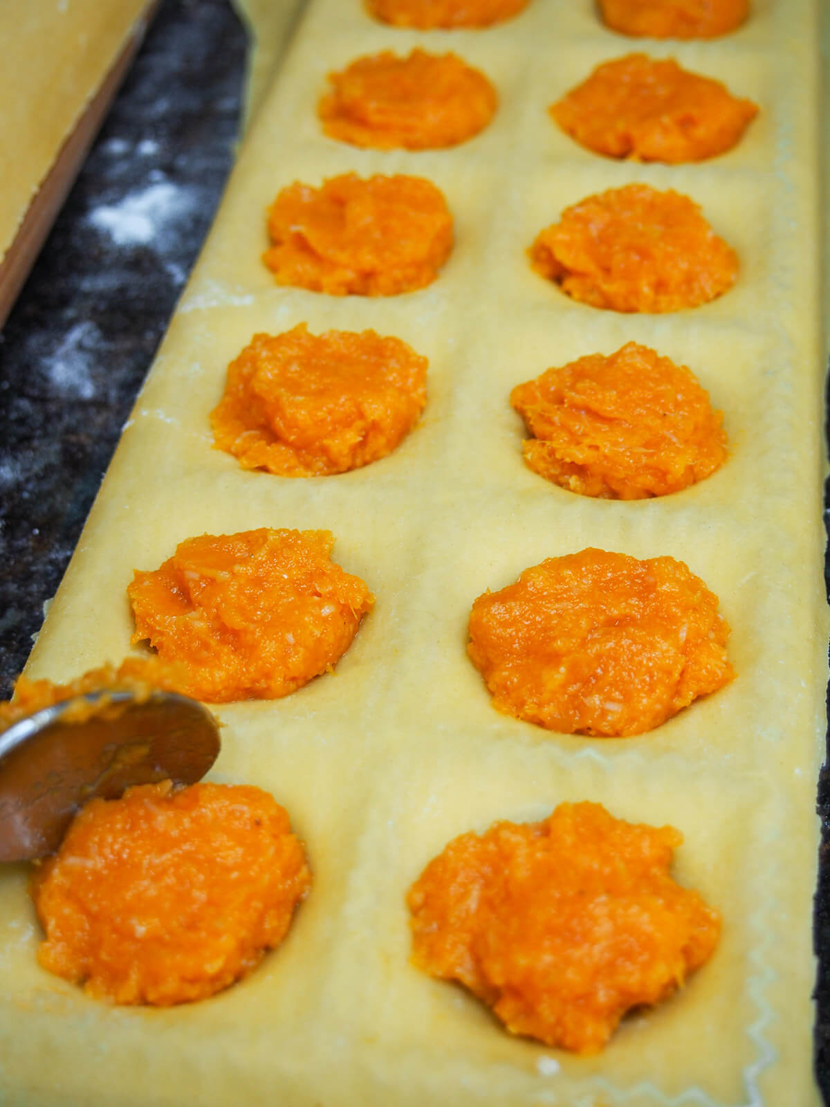 adding filling to pasta for ravioli