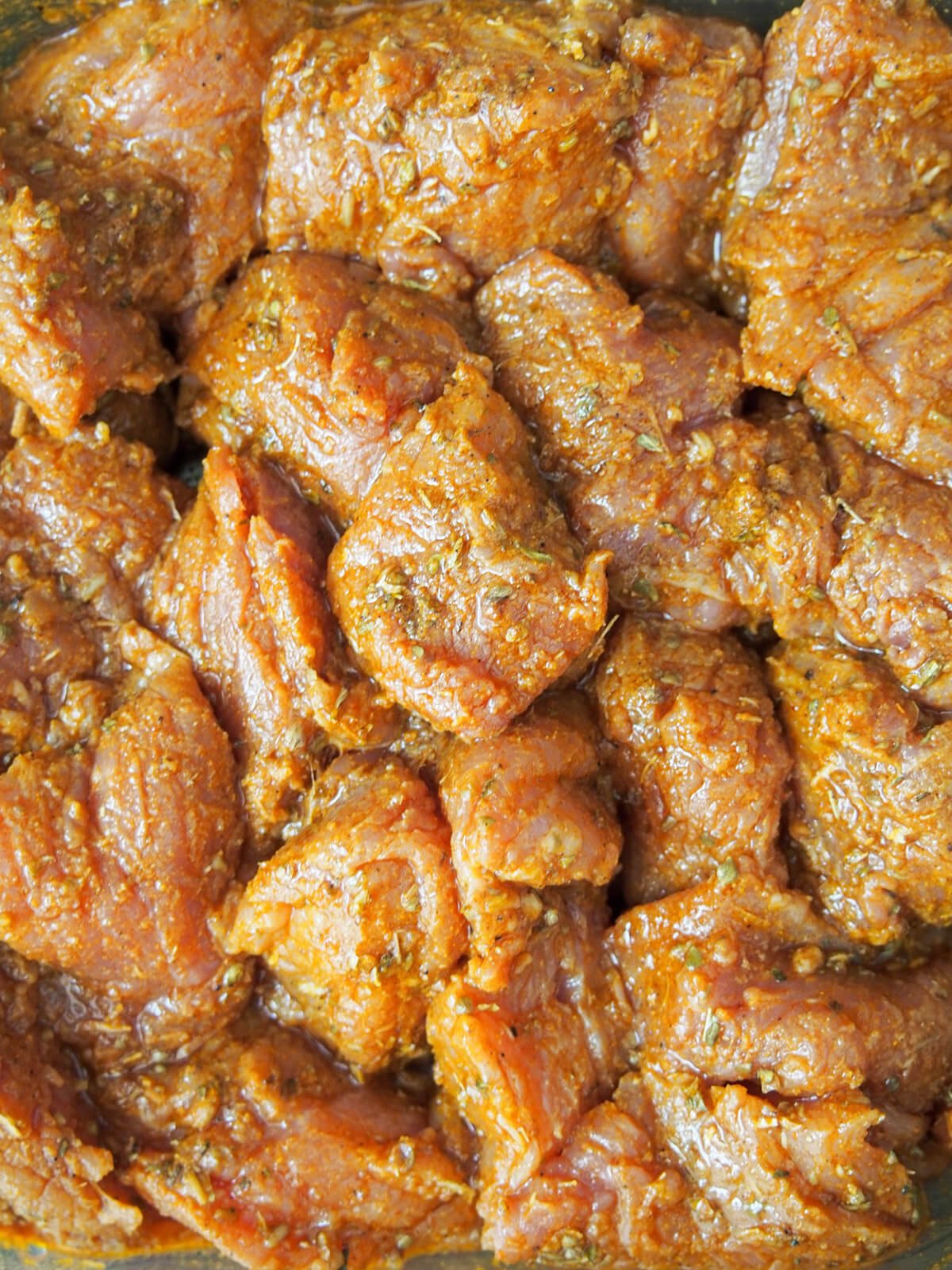 marinating pork for pinchos morunos pork covered in spice marinade