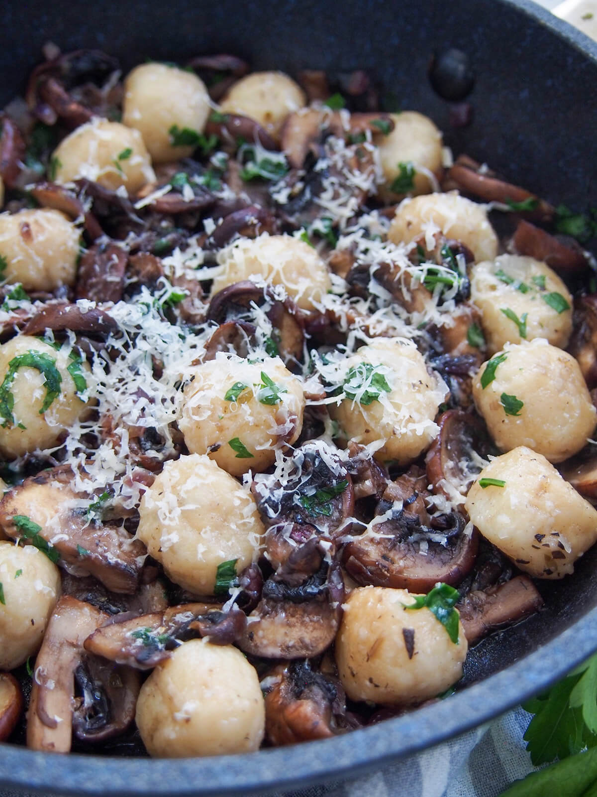 close up of mushroom gnocchi topped with cheese