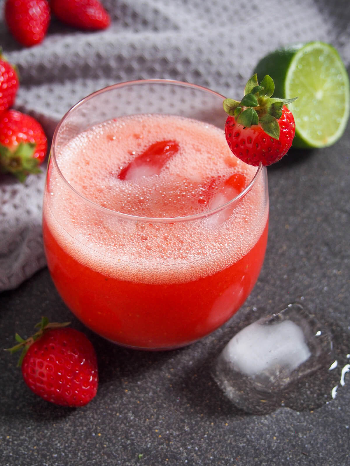 strawberry agua fresca with strawberry garnish on glass