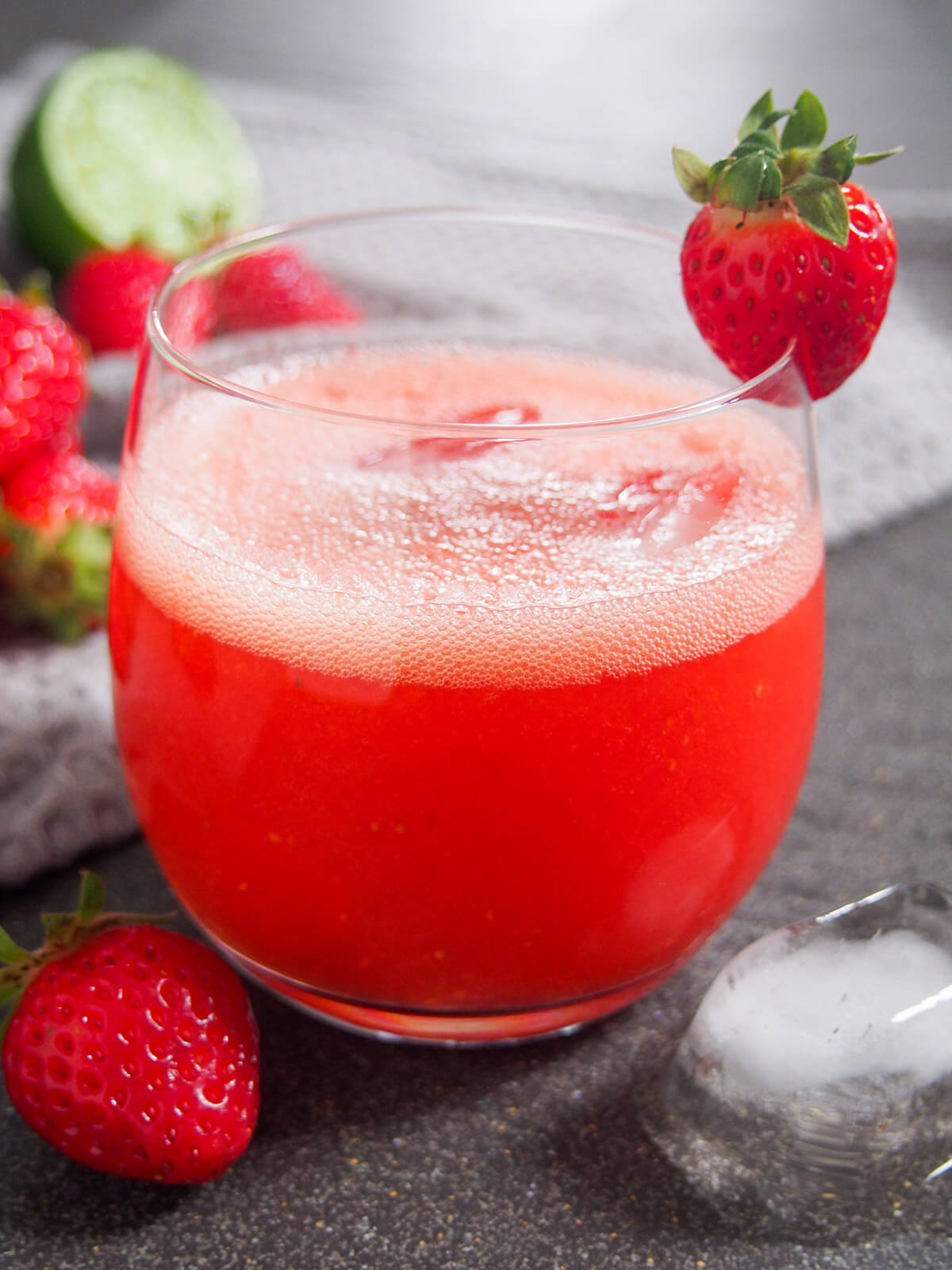 side view of glass of strawberry agua fresca