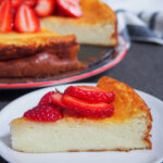 slice of Swedish cheesecake ostkaka on plate with rest behind