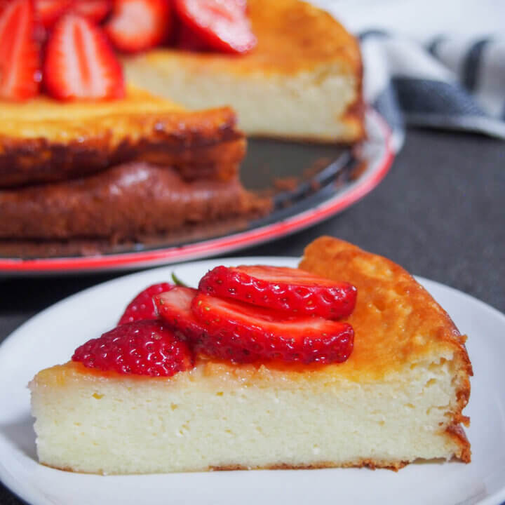 slice of Swedish cheesecake ostkaka on plate with rest behind