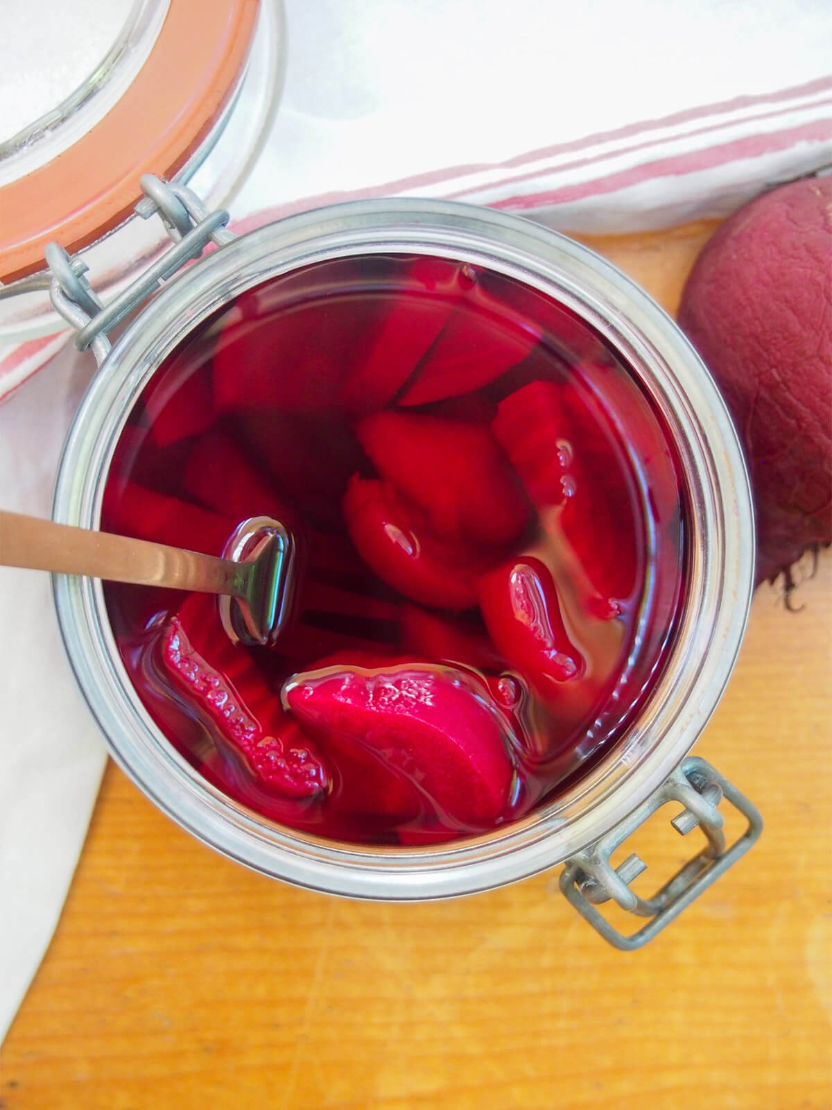These Swedish pickled beets are so easy to make and have a great sweet-tart flavor. You can enjoy them on their own, to top sandwiches or mixed in salads. They're a popular side for good reason. jar of Swedish pickled beets viewed from overhead with fork in jar