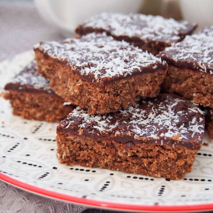 pieces of chocolate slice stacked on plate close up