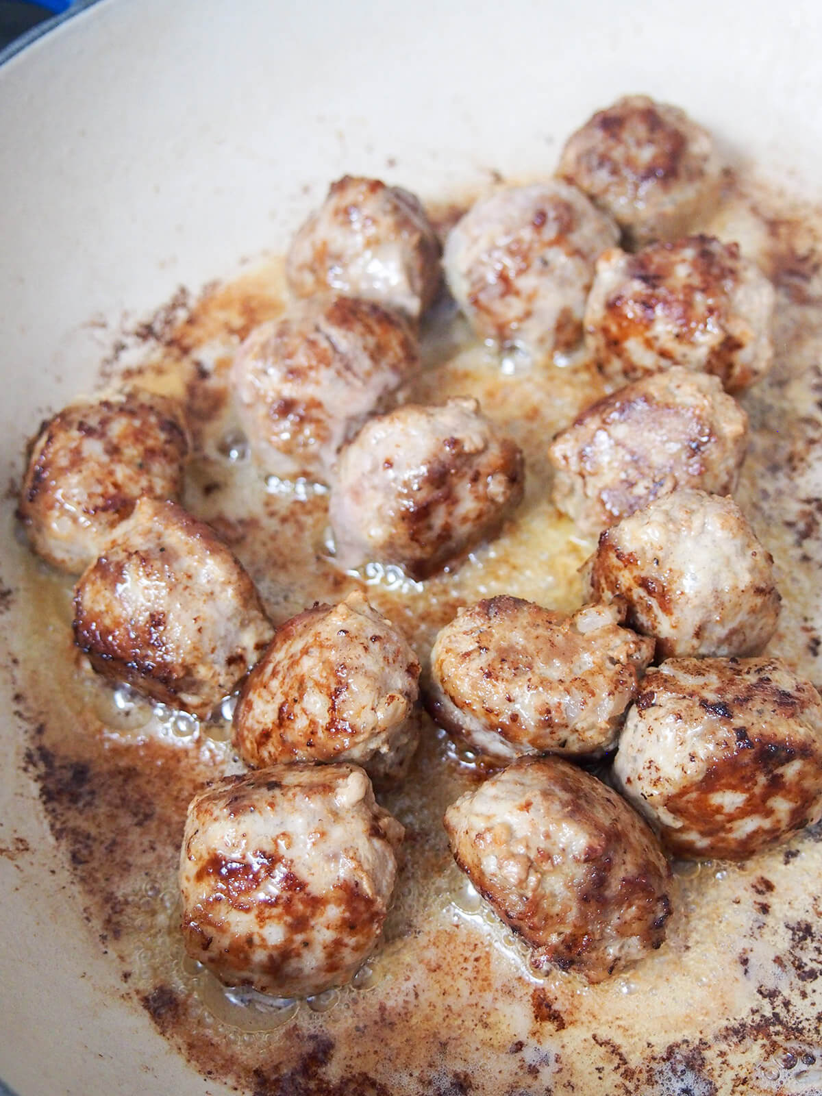 frying meatballs in cast iron dish