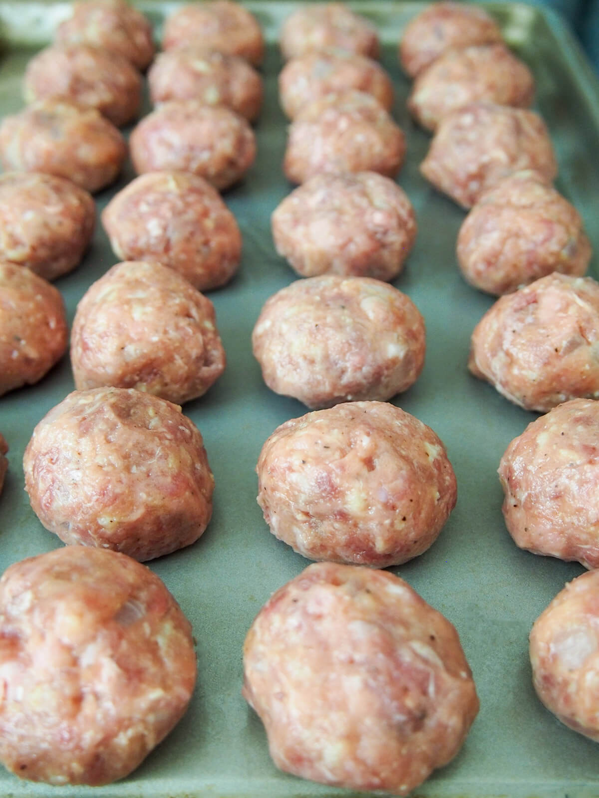 formed meatballs in rows on baking sheet