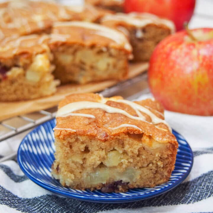 apple snack cake piece on small plate with more behind