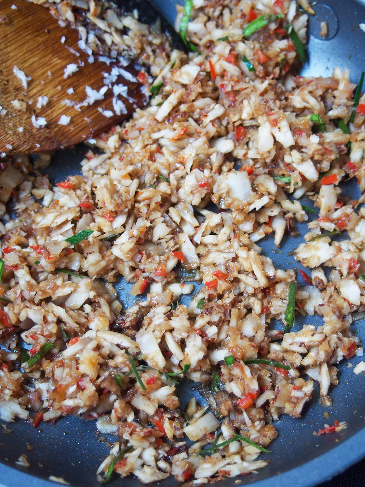 coconut topping for urap sayur cooking spiced coconut topping in skillet