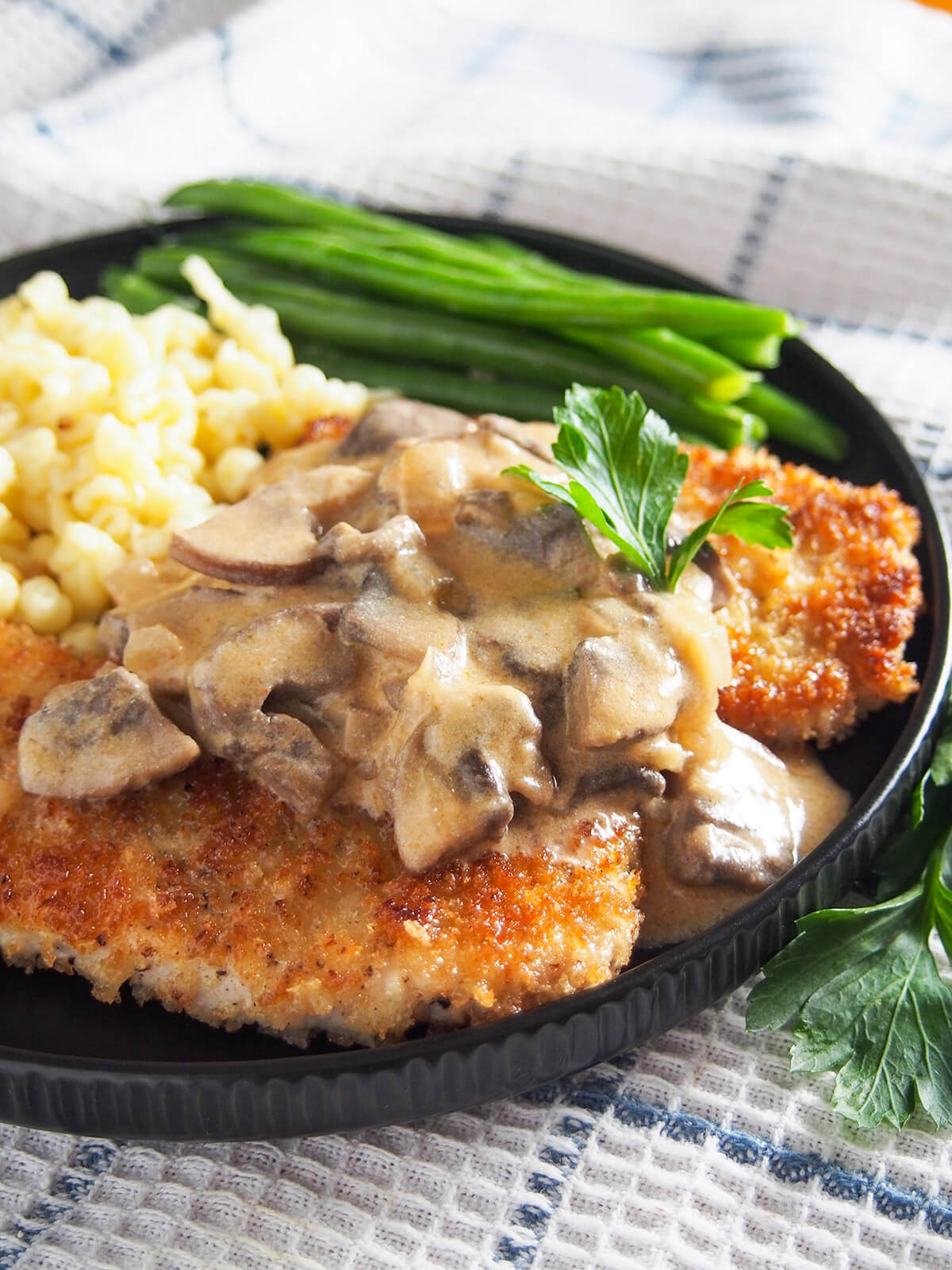 close up view of mushroom sauce on jaegerschnitzel