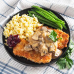 plate of jaegerschnitzel with beans and spaetzle