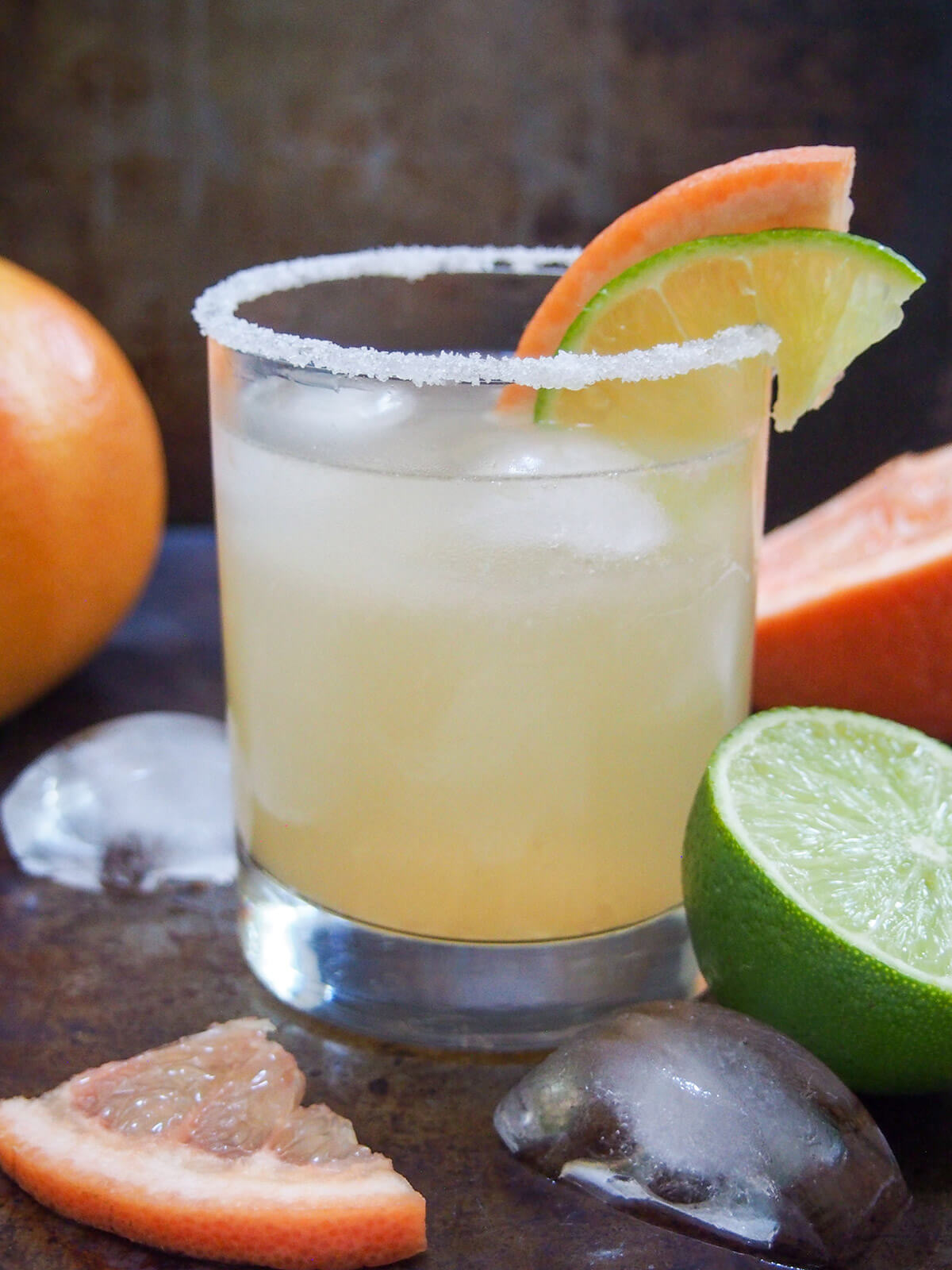 The Paloma cocktail is a wonderfully easy classic tequila-based cocktail. Made with fresh grapefruit juice gives it a bright, fresh flavor profile - a perfect balance of sweet and tart flavors, and wonderful to sip on. side view of glass of paloma cocktail