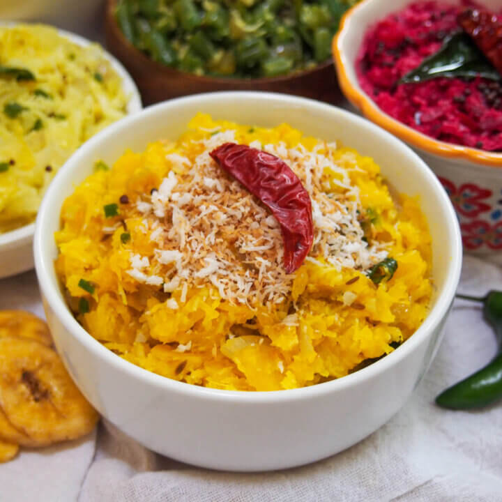 bowl of pumpkin erissery topped with coconut and chili